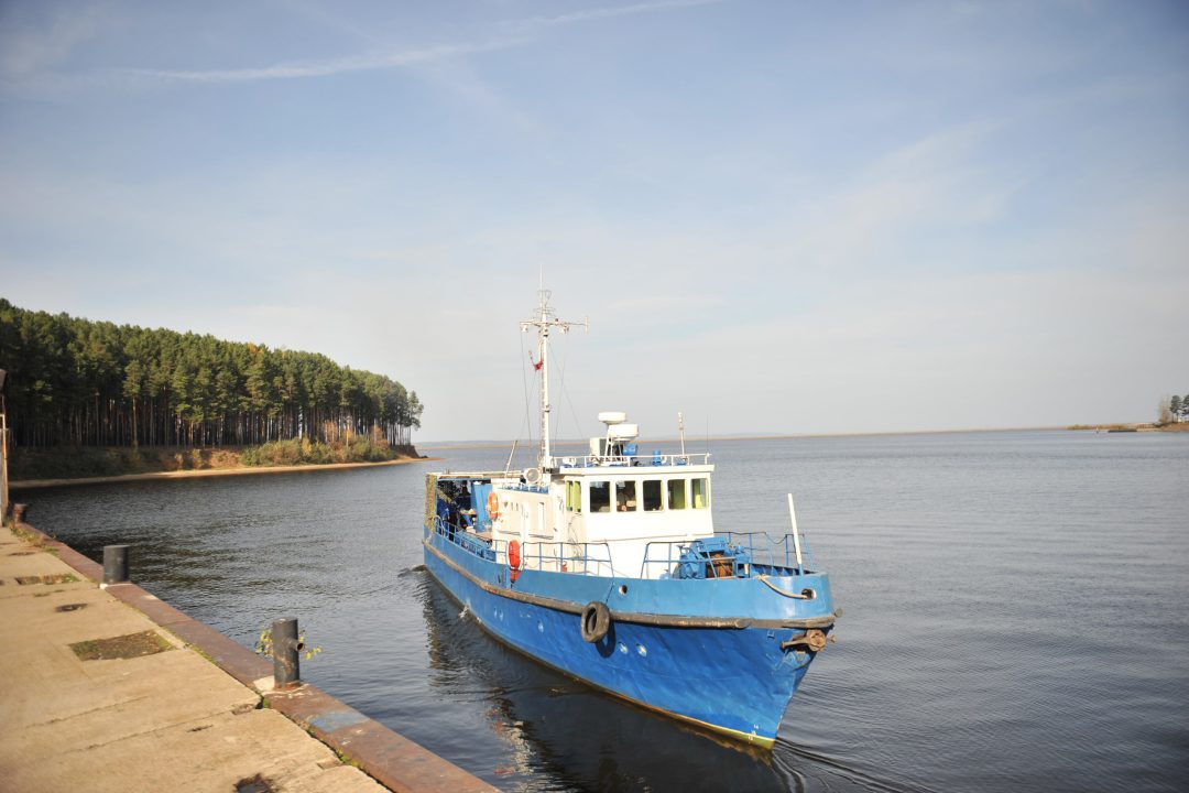 A small ship on a large river near the shore. Russia. The Kama River.