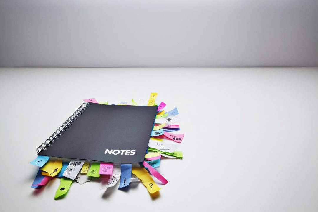 Studio shot of note pad full of post it notes